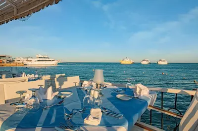 a table on a boat with boats in the water at Marlin Inn Azur Resort in Hurghada