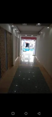 a hallway of a building with a rug on the floor at Enter compound in Hurghada