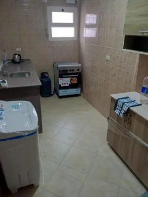 a kitchen with a stove and a sink at Eslam apartment 2 in Hurghada