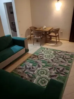 a living room with a couch and a table at Eslam apartment 2 in Hurghada