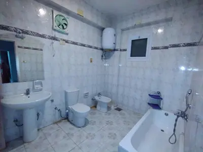 a bathroom with a sink and a toilet and a tub at جبل تقوق فيلا عبدالله محروس in Nag` el-Ramla