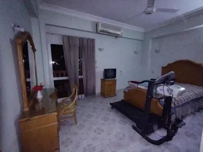 a bedroom with a bed with a treadmill in it at جبل تقوق فيلا عبدالله محروس in Nag` el-Ramla