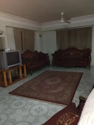 a living room with two couches and a television at جبل تقوق فيلا عبدالله محروس in Nag` el-Ramla