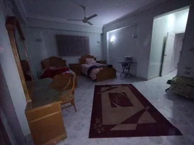 a room with a bedroom with a bed and a mirror at جبل تقوق فيلا عبدالله محروس in Nag` el-Ramla