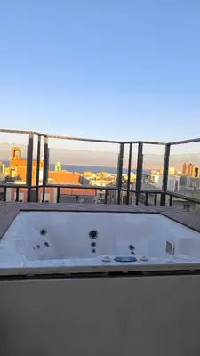 a bath tub on a balcony with a view of the city at Paradise Hill in Hurghada