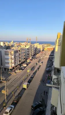 a city street with cars parked in a parking lot at Paradise Hill in Hurghada