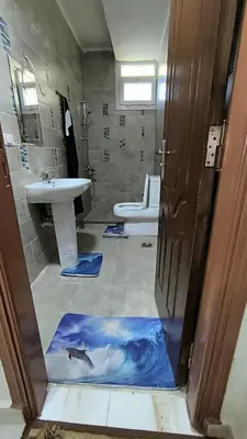 a bathroom with a sink and a bathroom with a dolphin painting on the floor at Paradise Hill in Hurghada