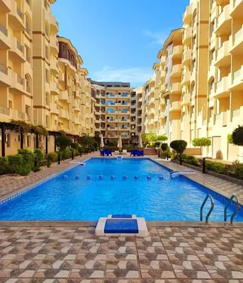 a large swimming pool in front of some apartment buildings at Luxury Sea view studio in Hurghada