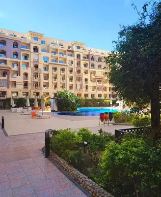 a large apartment building with a courtyard in front of it at Luxury Sea view studio in Hurghada