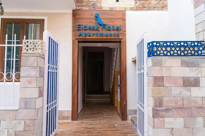 a building with a sign that reads elderly hotel appliances at Eldeak Hotel Apartments in Luxor