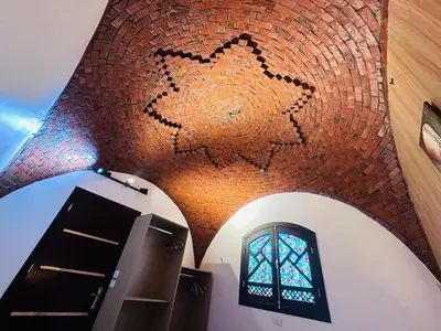a room with a brick wall and a window at Villa Farida Palace in Al Aqālitah