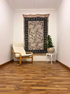 a room with a chair and a rug and a window at Touristic Center in Hurghada