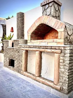 an outdoor brick oven in front of a building at Touristic Center in Hurghada