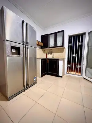 a large kitchen with a stainless steel refrigerator at Touristic Center in Hurghada