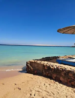 a stone wall on the beach near the ocean at Tiba Golden Resort in Hurghada