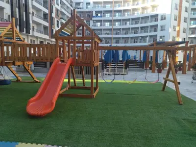 a playground with a red slide and a slide at Tiba Golden Resort apartment 167 in Hurghada