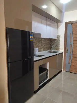 a kitchen with a black refrigerator and a sink at Tiba Golden Resort apartment 167 in Hurghada