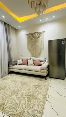 a living room with a couch and a large rug at Hasnaa apartment in Hurghada