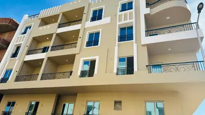 an apartment building with balconies on the side at Hasnaa apartment in Hurghada