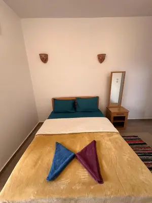 a bedroom with a bed with two bow ties on it at Palm Guest House in Aswan