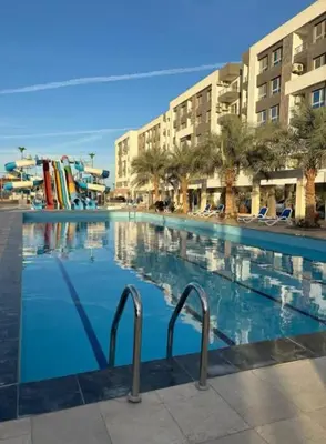a swimming pool with blue water in a resort at Fanadir bay in Hurghada