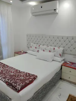 a white bed with white sheets and pillows on it at Fanadir bay in Hurghada