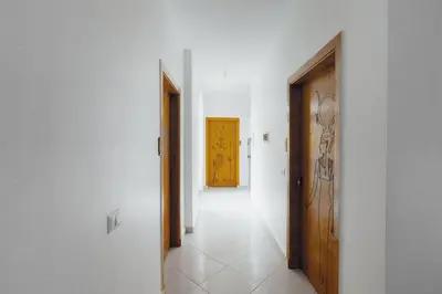 a hallway with two doors and a yellow door at Pharaohs Guest House in Luxor