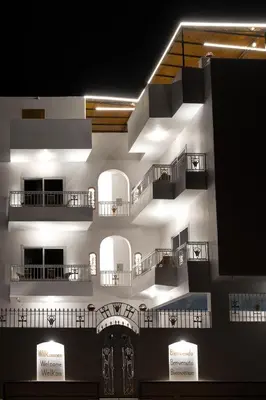 a building with several balconies and lights on it at Pharaohs Guest House in Luxor