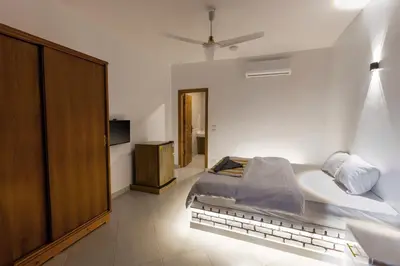 a bedroom with a bed and a tub in it at Pharaohs Guest House in Luxor