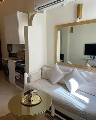 a living room with a white couch and a table at Serene Apartment Makadi Heights in Hurghada
