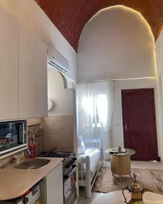 a kitchen with a sink and a stove top oven at Serene Apartment Makadi Heights in Hurghada