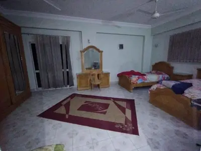 a living room with a bed and a mirror at فيلا عبدالله محروس in Aswan