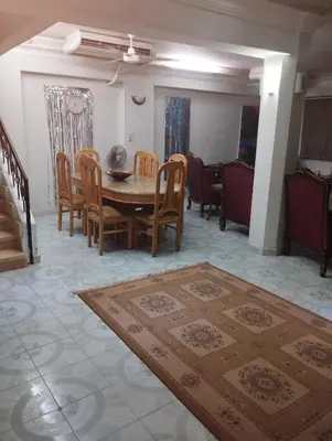 a living room with a wooden table and chairs at فيلا عبدالله محروس in Aswan