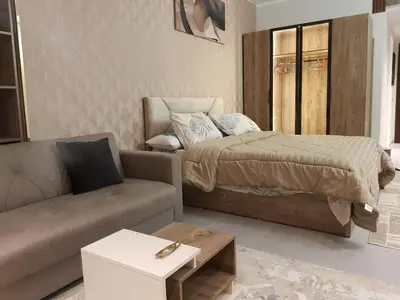 a living room with a bed and a couch at Scandic Resort Hurghada in Hurghada