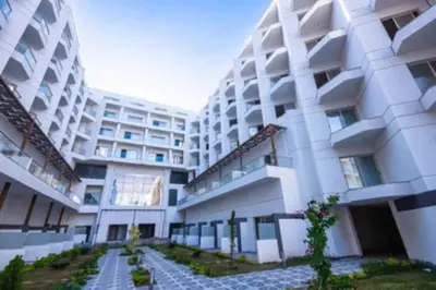 a large white building with a pathway in front of it at Scandic Resort Hurghada in Hurghada