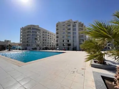 a swimming pool in front of two tall buildings at Scandic Resort Hurghada in Hurghada