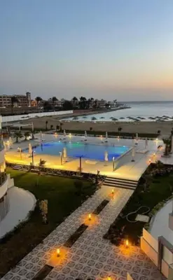 an overhead view of a pool with the ocean in the background at Scandic Resort Hurghada in Hurghada