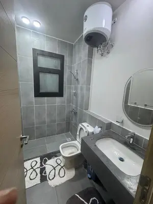a bathroom with a sink and a toilet and a mirror at luxury apartment Makadi heights phase 2 in Hurghada