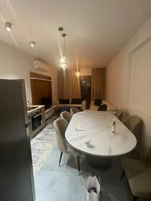 a room with a table and chairs and a living room at luxury apartment Makadi heights phase 2 in Hurghada