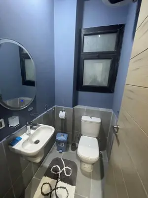 a bathroom with a toilet and a sink and a mirror at luxury apartment Makadi heights phase 2 in Hurghada