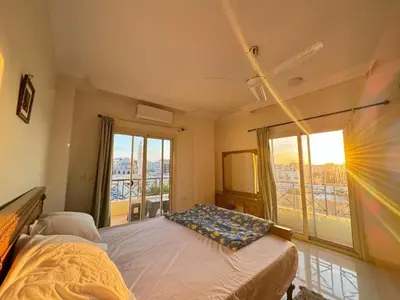 a bedroom with a bed and a large window at Hurghada Concierge at Casablanca Resort in Hurghada