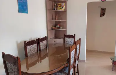 a dining room table and chairs with a table and a shelf at Hurghada Concierge at Casablanca Resort in Hurghada