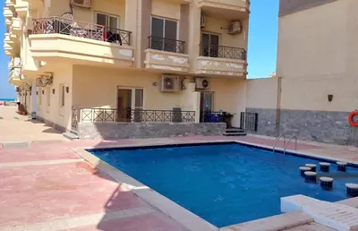 a swimming pool in front of a building at Hurghada Concierge at Casablanca Resort in Hurghada