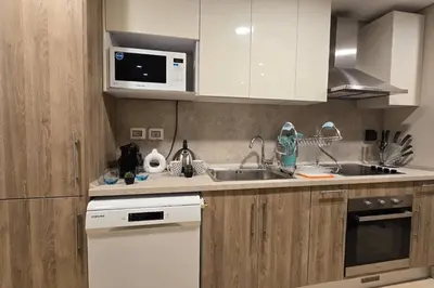 a kitchen with a sink and a microwave at Mangroovy 1 br Ground Composure & Cool Hilton view in Hurghada