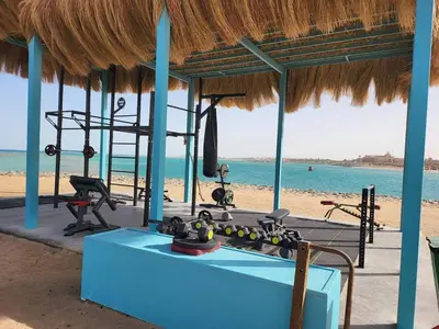 a gym on the beach with the ocean in the background at Mangroovy 1 br Ground Composure & Cool Hilton view in Hurghada