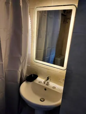 a bathroom with a sink and a mirror at Aquarium Seaview accomodations in Hurghada