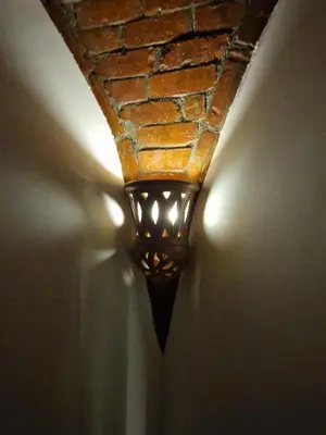 a light on a wall with a brick ceiling at House Mountain in ‘Ezbet Abu Ḥabashi