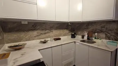 a kitchen with white cabinets and a sink at House Mountain in ‘Ezbet Abu Ḥabashi