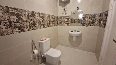 a bathroom with a toilet and a sink at House Mountain in ‘Ezbet Abu Ḥabashi