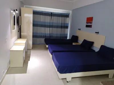 a small room with two beds and a window at Aquarium Seaview accomodations in Hurghada